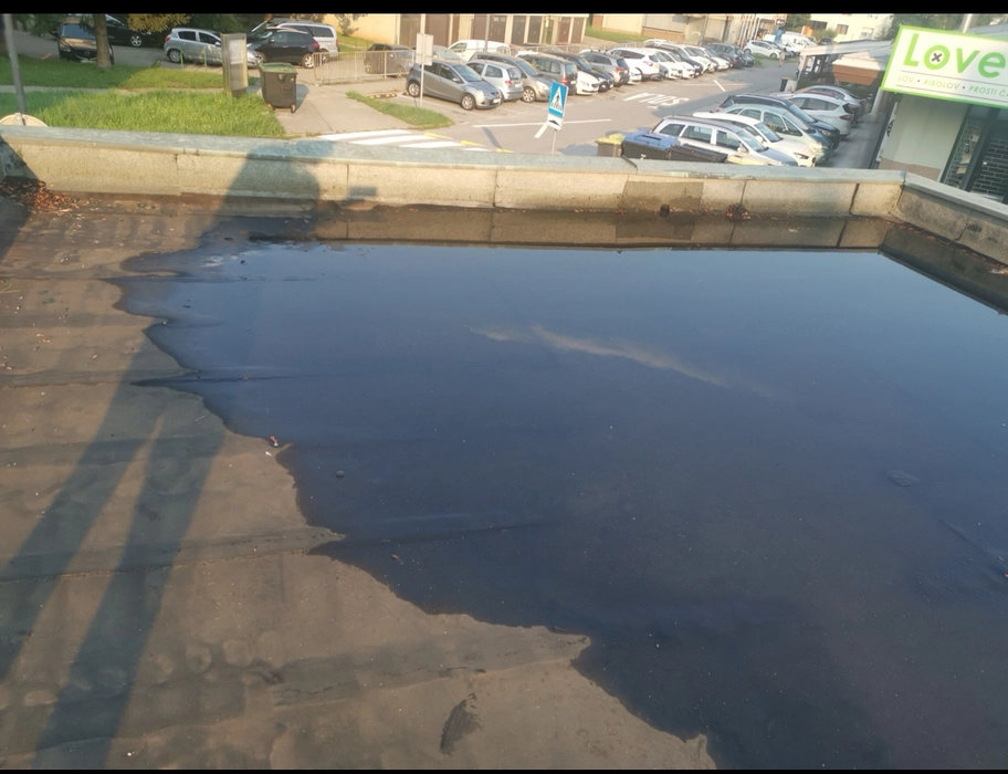 Zadržana voda na ravnoj krovnoj površini koja ističe potencijalne probleme s odvodnjom.